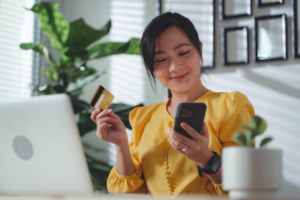 Female holding a phone and a card