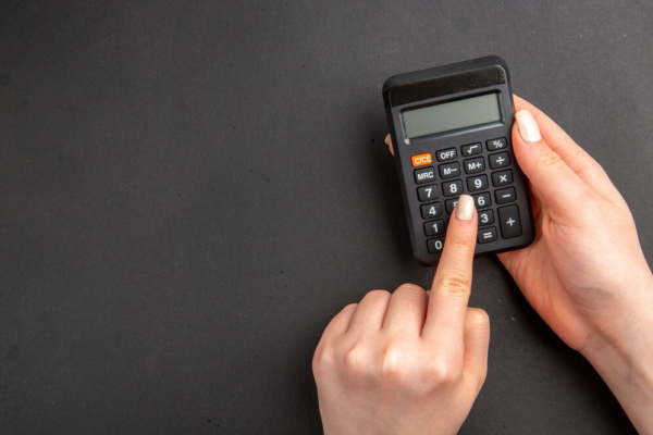 hand holding a calculator